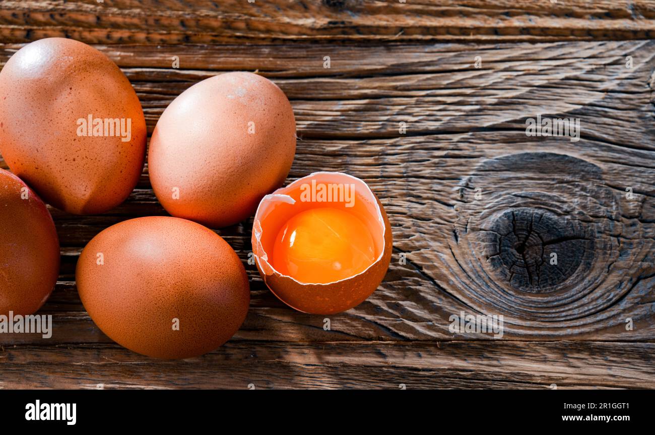 Composition with five chicken eggs on a wooden table Stock Photo