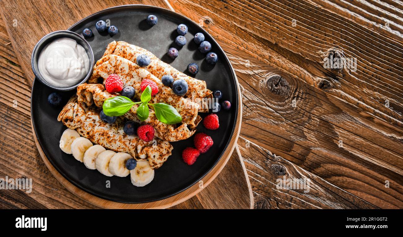 A plate of pancakes with cheese and fruits Stock Photo
