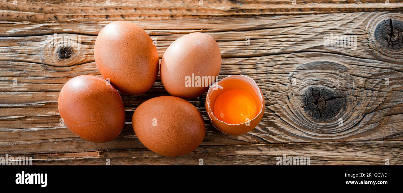 Composition with five chicken eggs on a wooden table Stock Photo