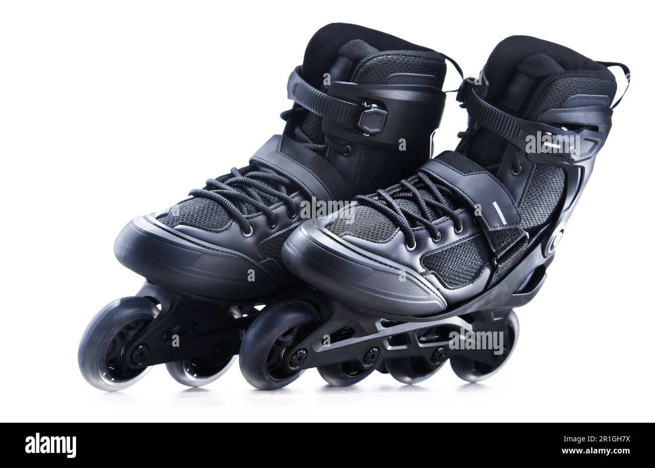 A pair of black inline skates isolated on white background Stock Photo