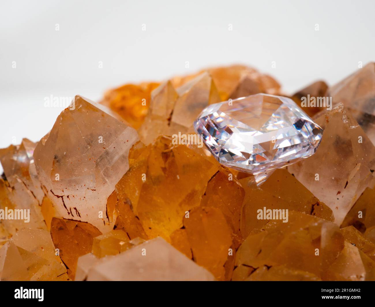 Sparkling asscher cut diamond with rough stone background Stock Photo