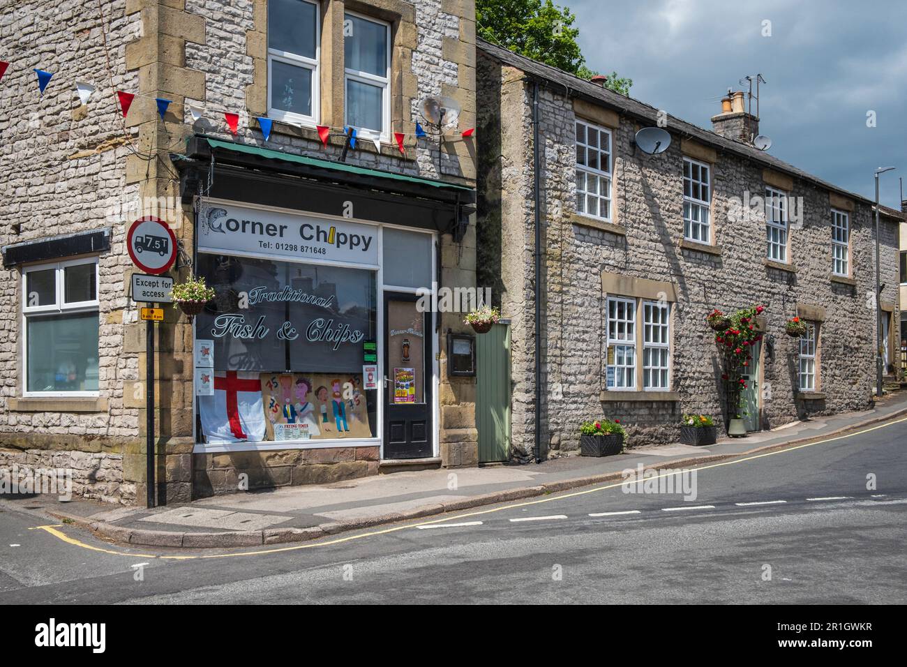 The Corner Chippy fish and chip shop with a window display marking the 75th anniversary of VE Day, Tideswell, Peak District National Park, Derbyshire Stock Photo