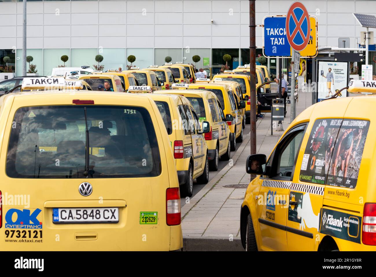Yellow taxi cabs waiting for fare at the Sofia Airport Terminal 2 taxi rank, Sofia, Bulgaria, Eastern Europe, Balkans, EU Stock Photo