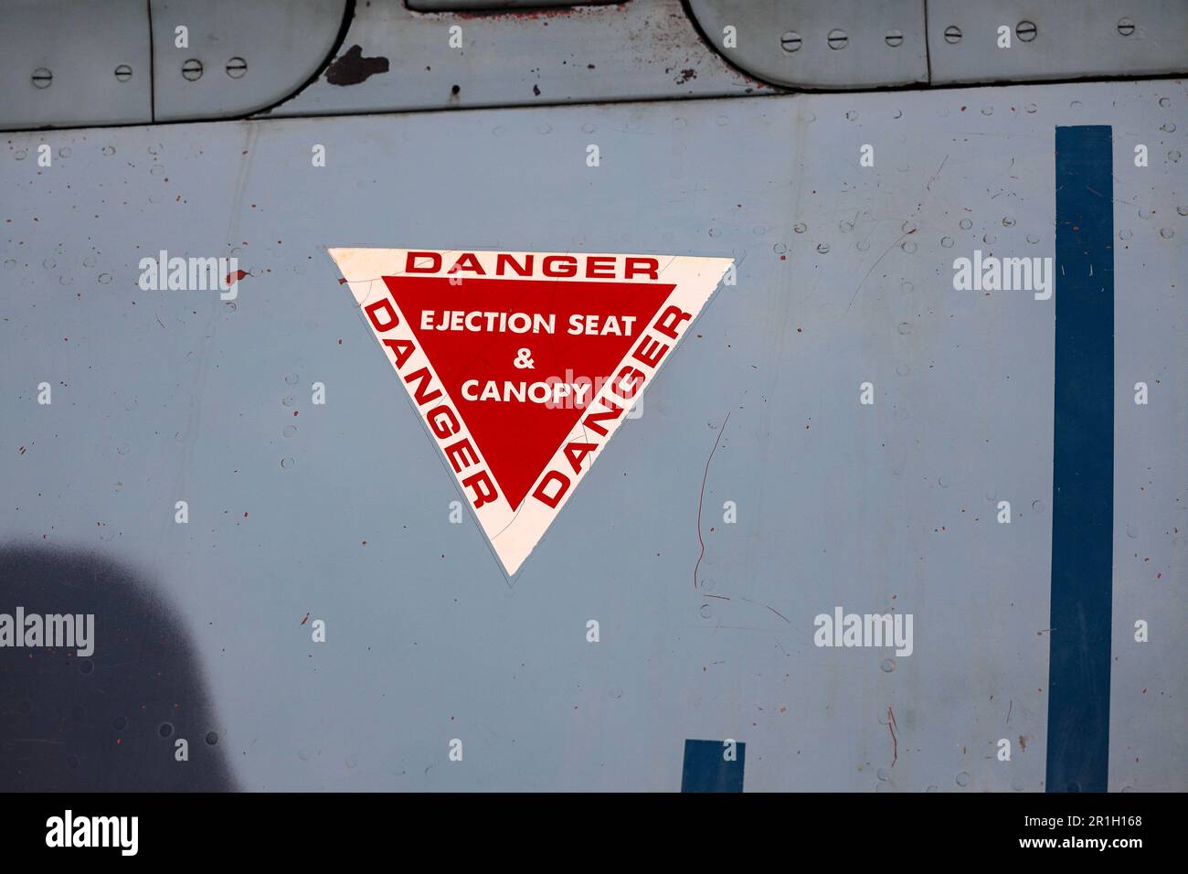 Ejection seat warning sign on fuselage of modern jet fighter. Stock Photo