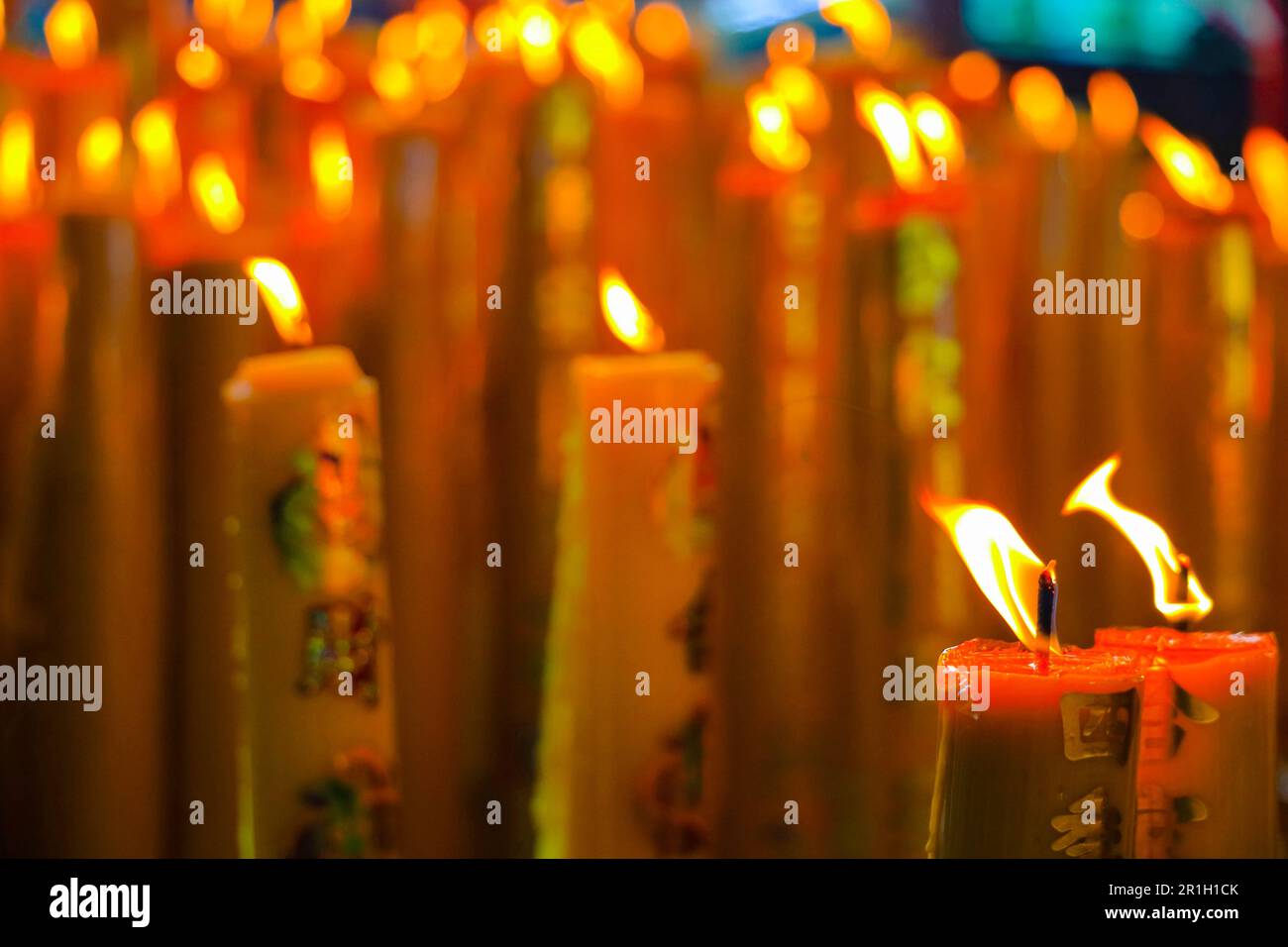 yellow wax chinese candles with lucky symbol burning red Chinese candle
