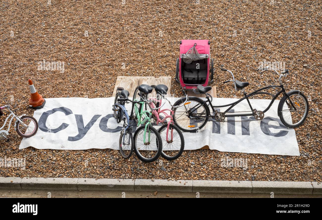 A large sign saying "Cycle Hire" and various bicycles for hire on the