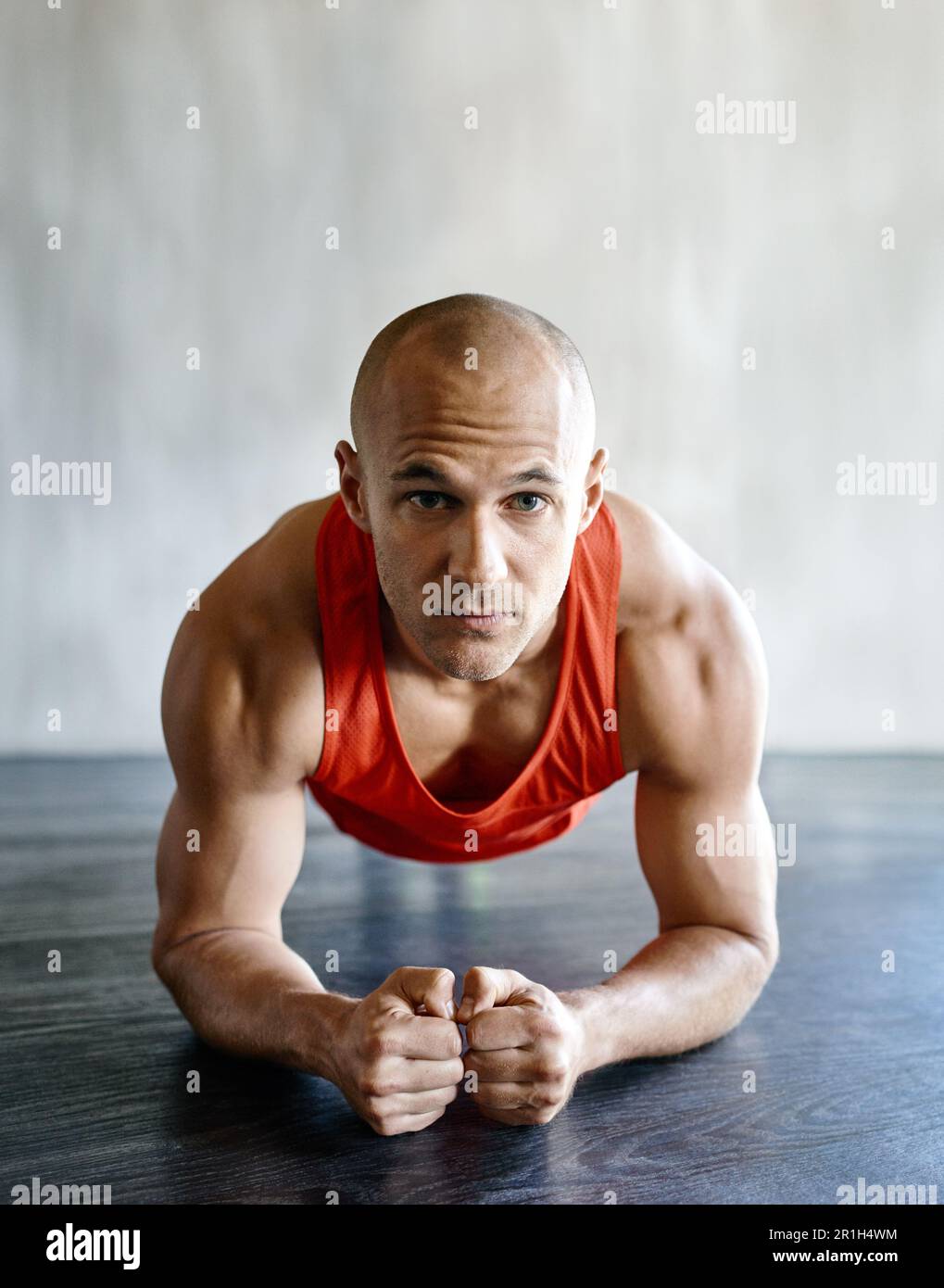 Gym floor, portrait and fitness man focus on plank exercise, health