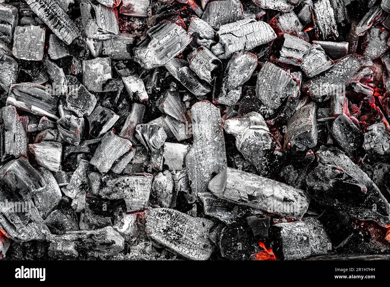 Fire Remnants Texture The texture of burning firewood and charcoal with the remnants of the ...
