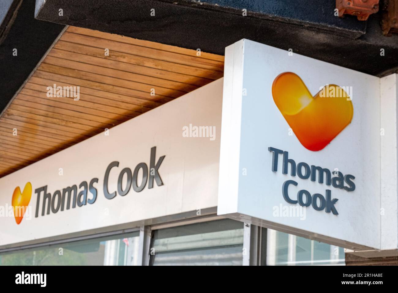 Thomas Cook travel agent shop sign on outside wall UK Stock Photo