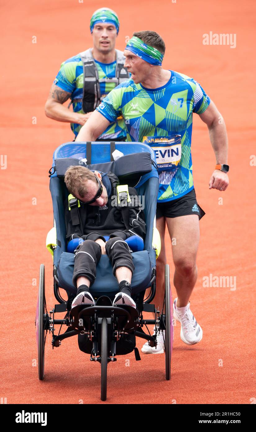 Rob Burrow and Kevin Sinfield approach the finish line of the 2023 Rob ...