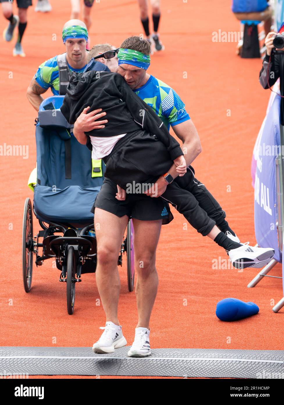 Rob Burrow and Kevin Sinfield cross the finish line of the 2023 Rob