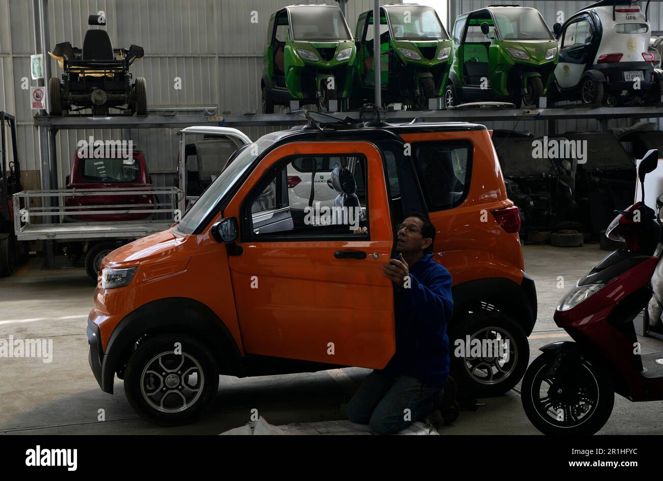 An employee works on a Quantum electric car at a factory in Cochabamba