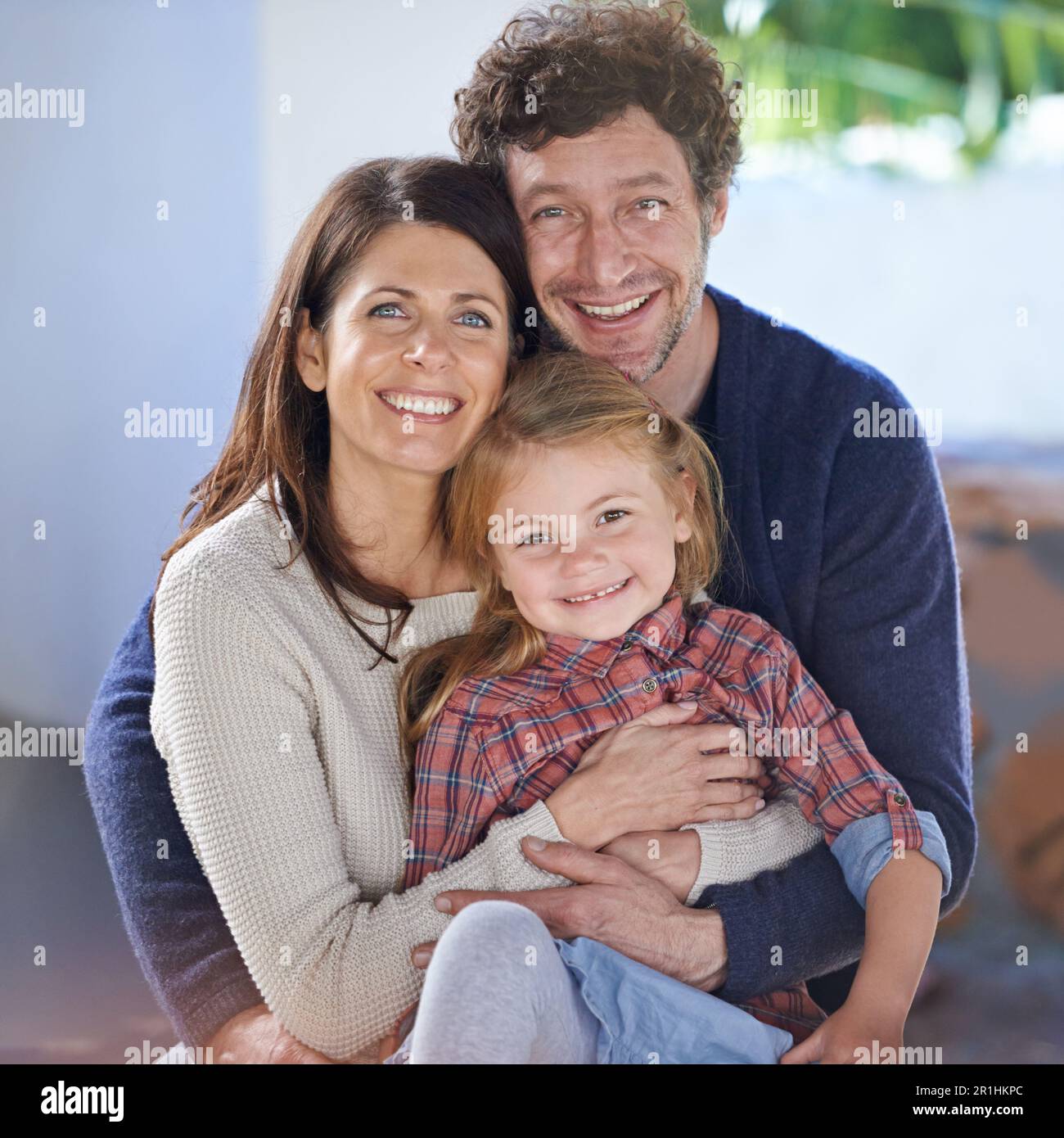 Family hug in portrait, relax in backyard with mom and dad with kid ...