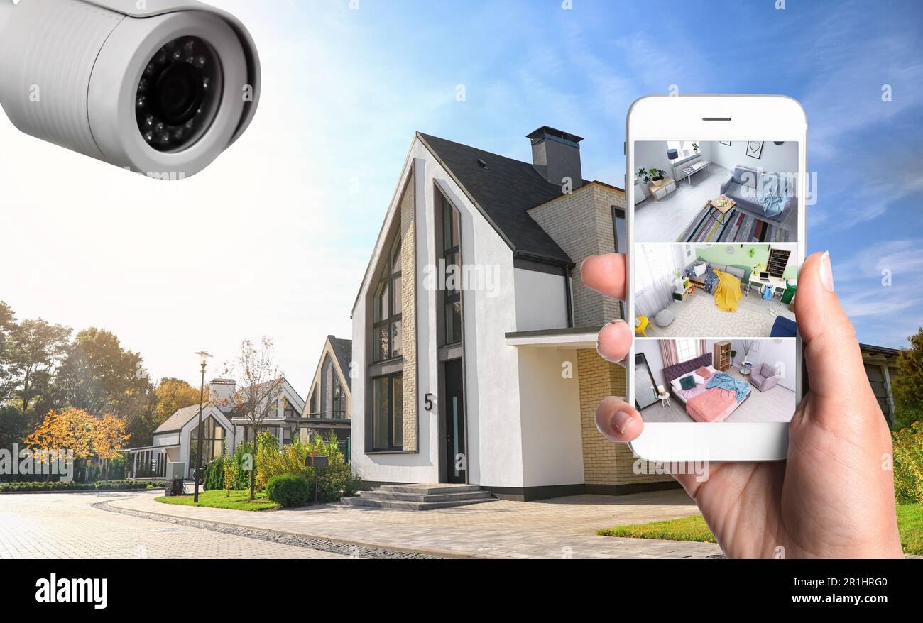Home security system. Woman monitoring CCTV cameras on smartphone near her house, closeup Stock Photo