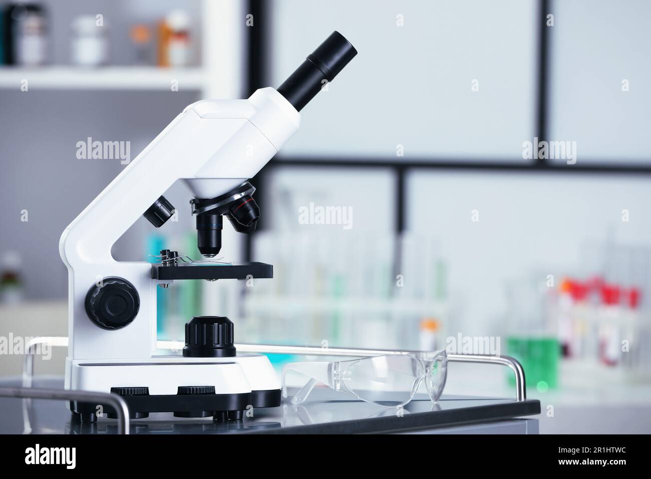 Modern medical microscope on metal table in laboratory, space for text Stock Photo
