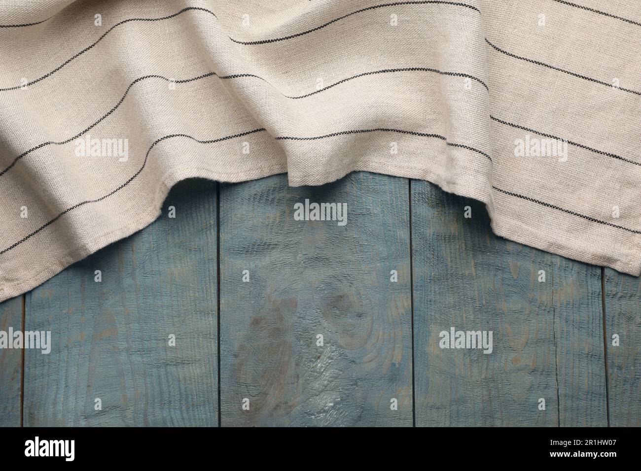Kitchen towel on blue wooden background, top view. Space for text Stock Photo