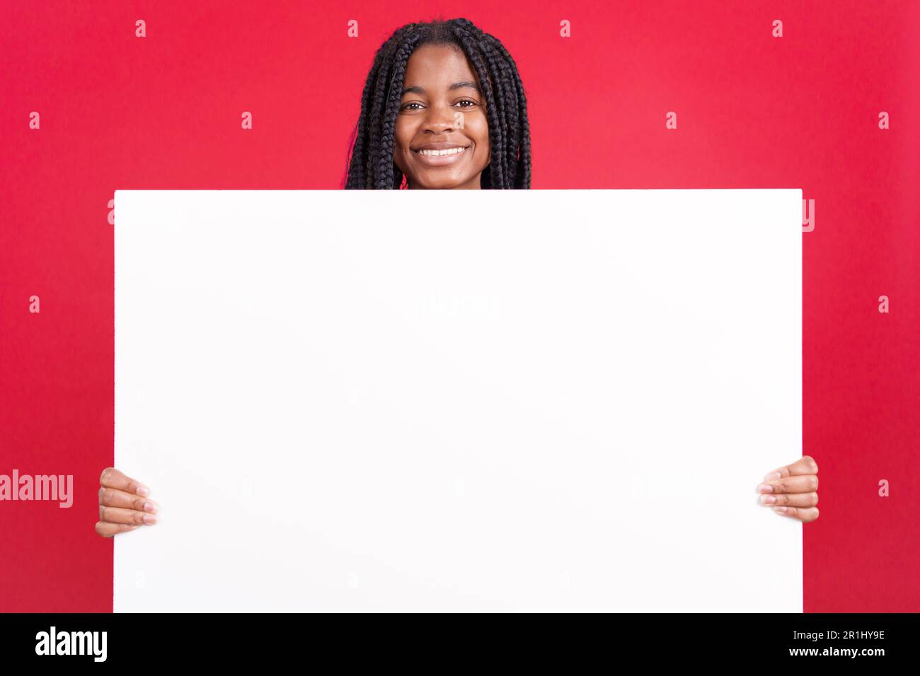 African woman holding a blank panel while smiling Stock Photo - Alamy