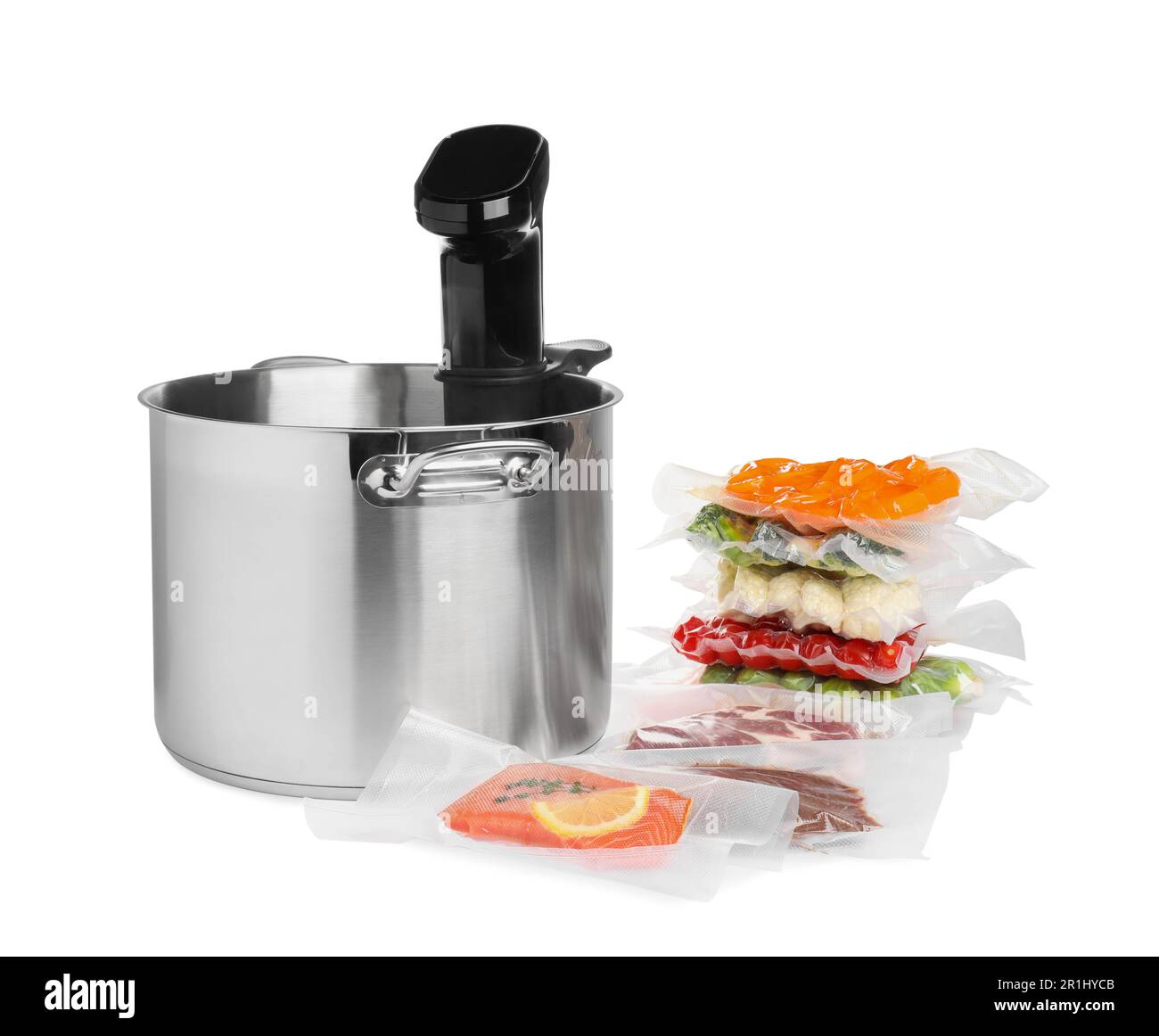 Thermal immersion circulator in pot and vacuum packs with different food products on white