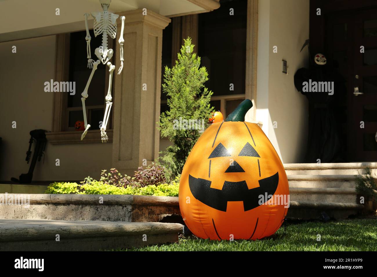 Inflatable Jack O'Lantern near house decorated for Halloween Stock