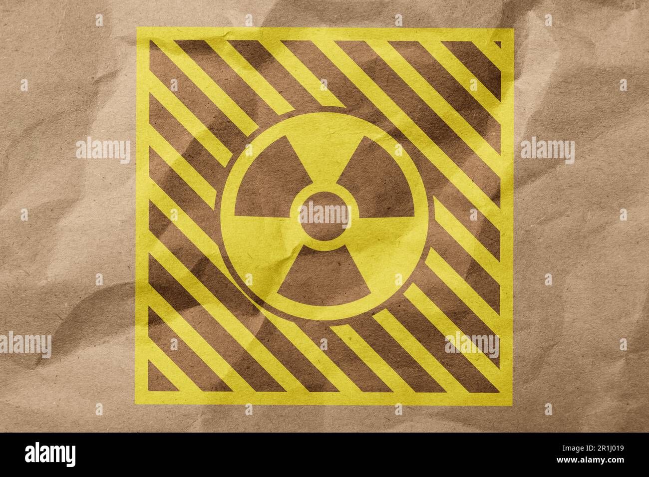 Radioactive sign on crumpled kraft paper. Hazard symbol Stock Photo