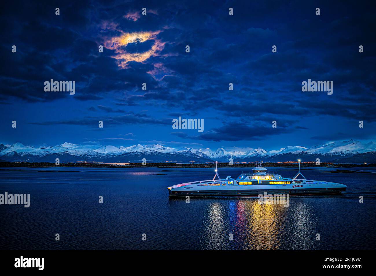 The ferry towards Molde in Norway during moonlight in spring Stock Photo