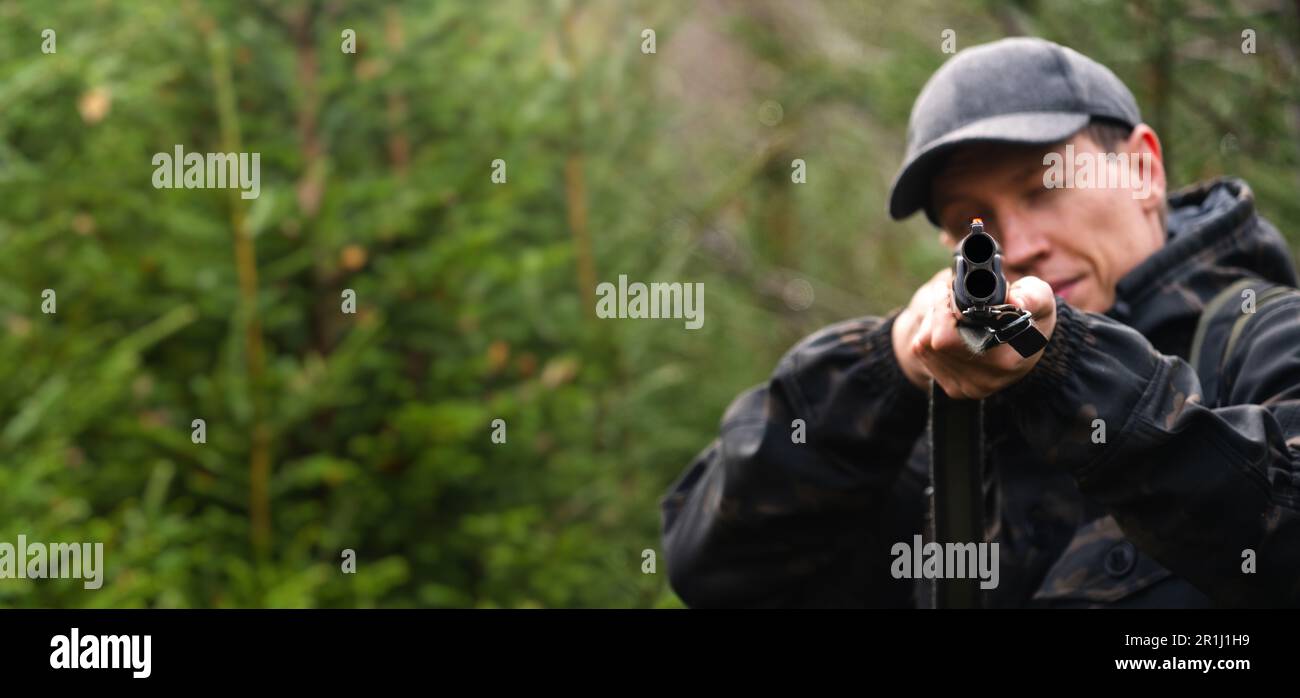 Hunter with a gun in the forest. High quality photo Stock Photo