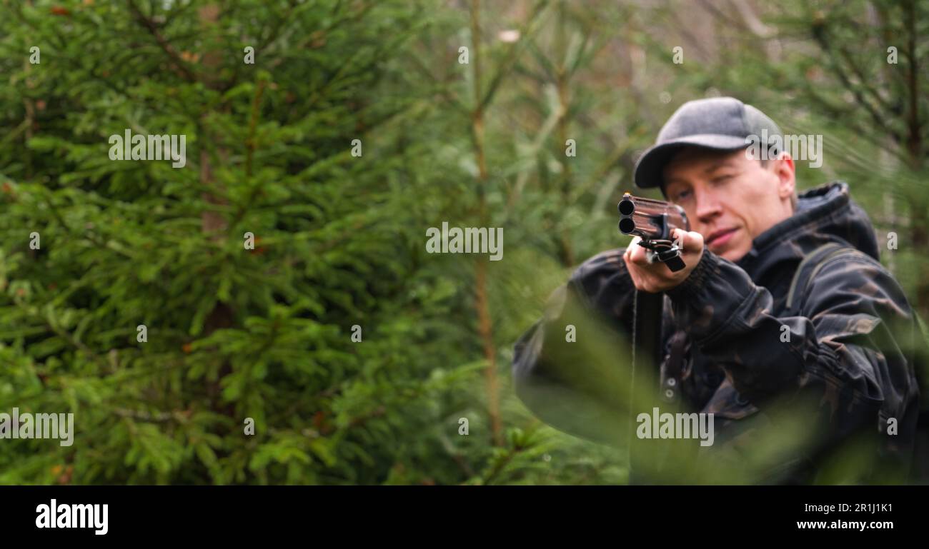 Hunter with a gun n the forest. High quality photo Stock Photo