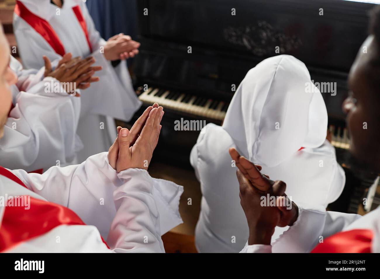 Group of people from church choir clapping and singing during