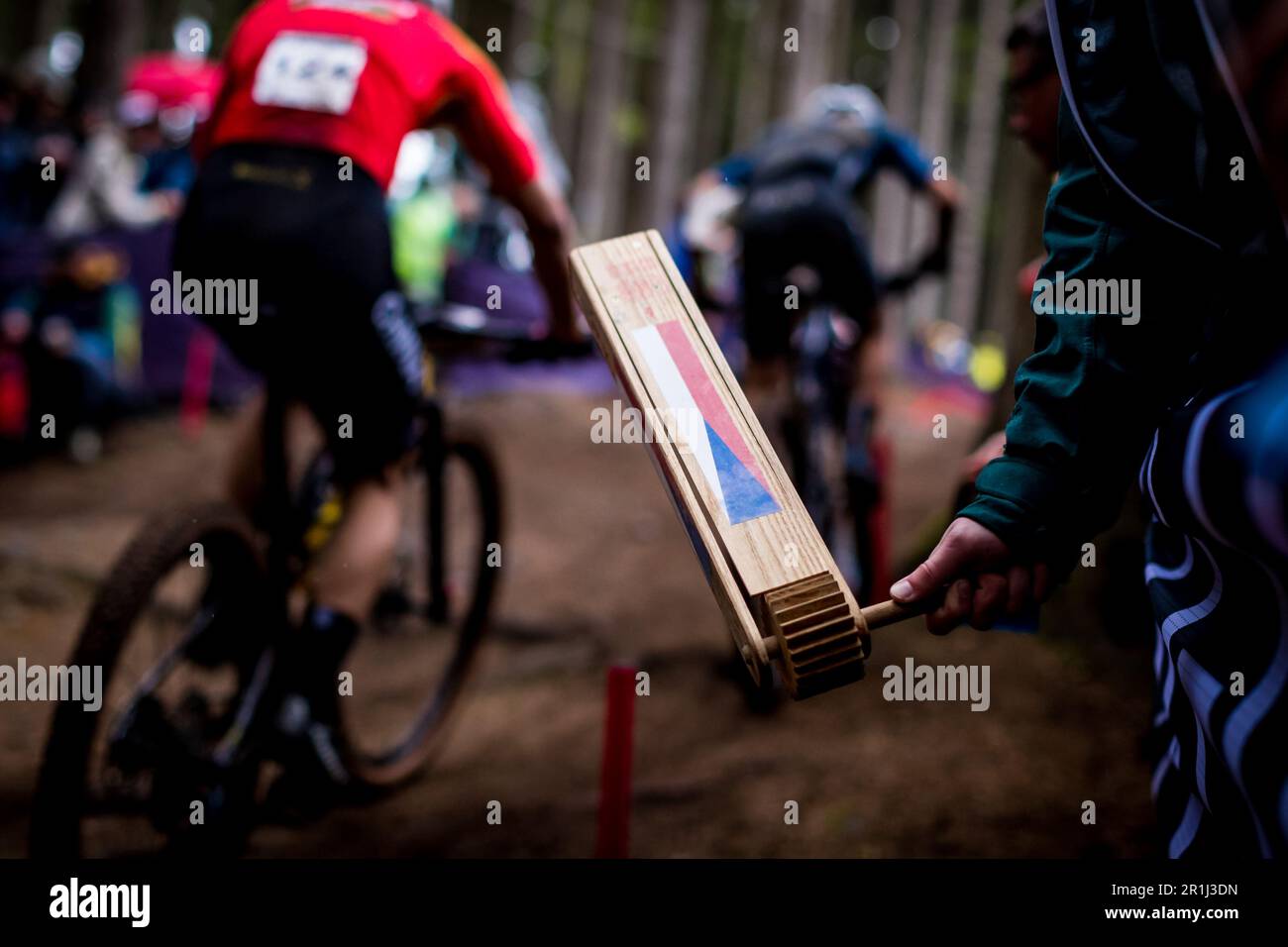 Nove Mesto na Morave, Czech Republic. 14 May, 2023. Czech fan supports cyclists by a ratchet witch Czech flag during the Men ELITE cross-country race within the UCI Mountain Bike World Cup, on May 14, 2023, in Nove Mesto na Morave, Czech Republic. (CTK Photo/Jaroslav Svoboda) Credit: CTK/Alamy Live News Stock Photo