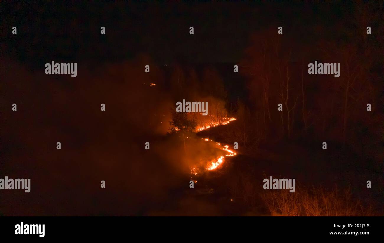 Night fire in the forest with fire and smoke.Epic aerial photo of a ...