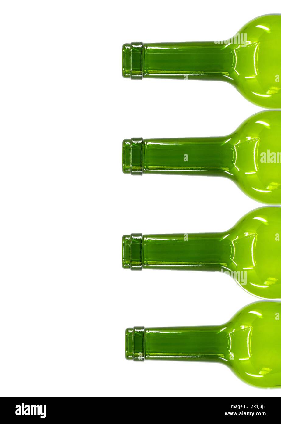 Tops and necks of empty wine bottles stacked on tyop of one another isolated on a plain white background. Alcohol consultion concept. Copy space. Stock Photo
