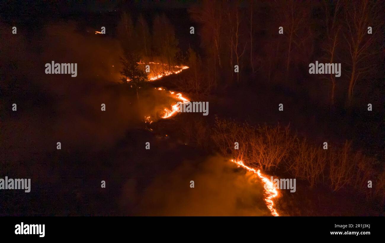 Night fire in the forest with fire and smoke.Epic aerial photo of a ...