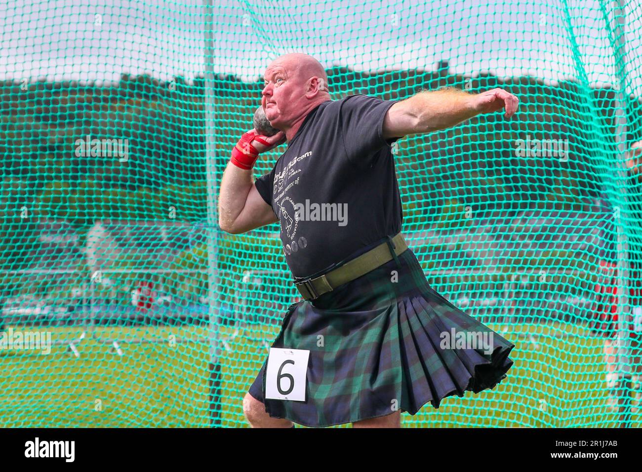 Gourock, UK. 14th May, 2023. The first Highland Games of the 2023 season took place at Battery Park, Gourock, Scotland, when competitors from Scottish Country Dancing, pipe bands and the traditional "Scottish Highland Heavy" competitions. ALAN BUTLER throwing the stone. Credit: Findlay/Alamy Live News Stock Photo