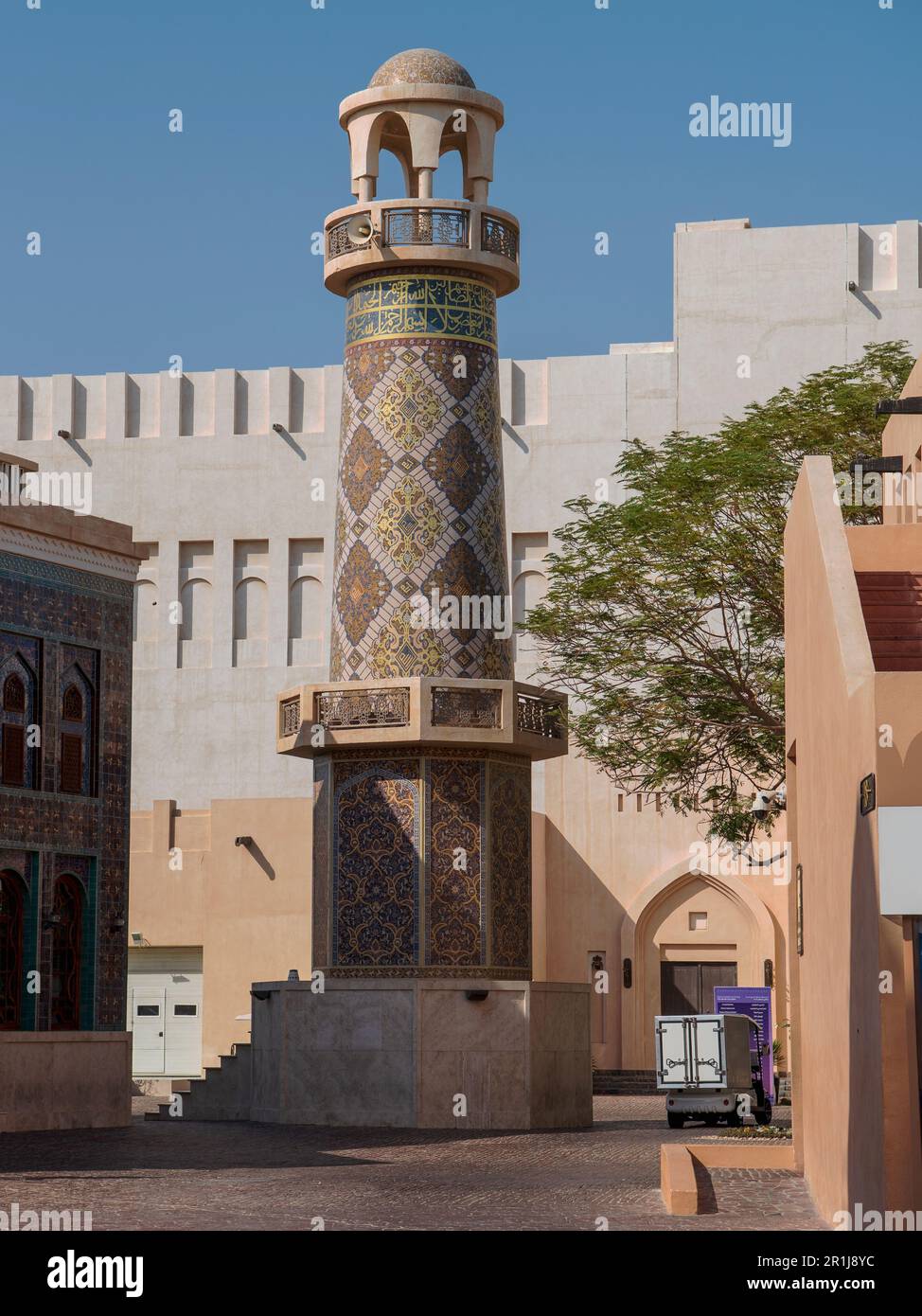 The beautiful Minaret of the ornamented Mosque In Katara Village is adorned with handcrafted glass mosaics Persian patterns. This marvelous house of w Stock Photo