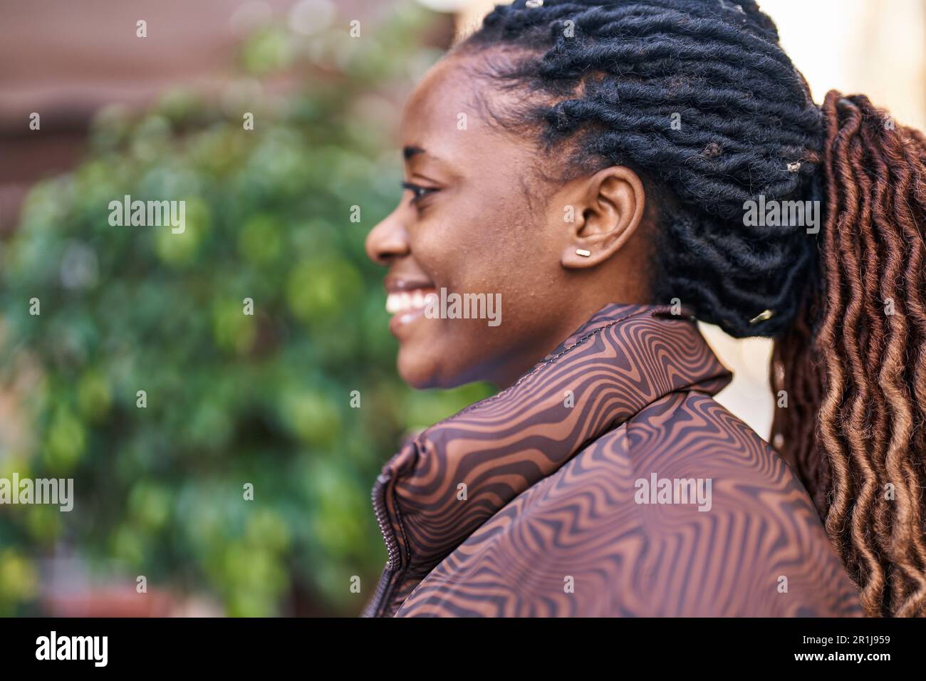 African american woman smiling confident looking to the side at street ...