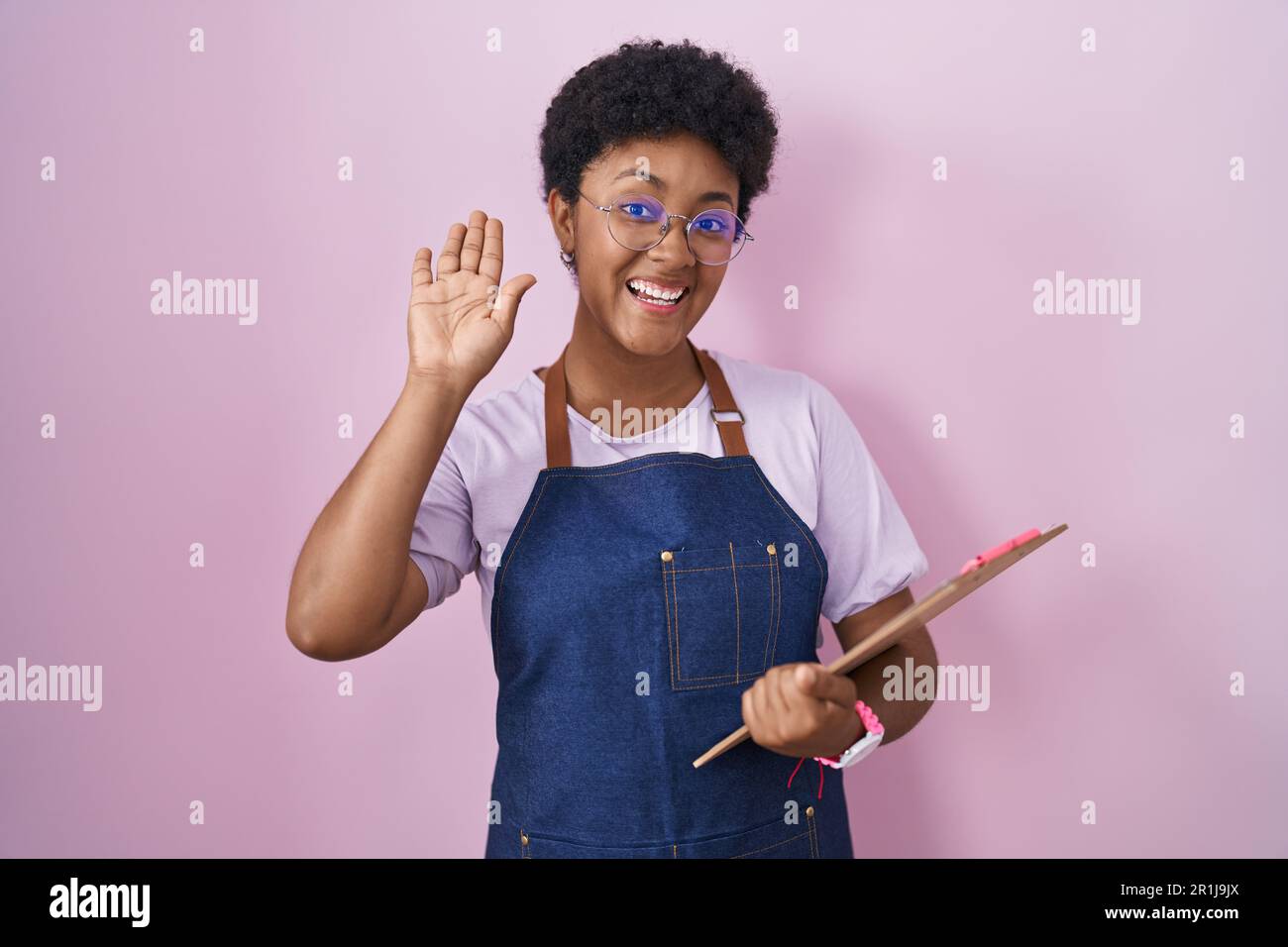 Hello Waitress Young african american woman wearing professional waitress apron ...