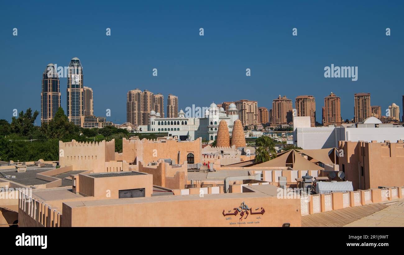 View from the amphitheater over the roofs of Katara Cultural Village and the highrises of Doha's Pearl Isalnd Stock Photo