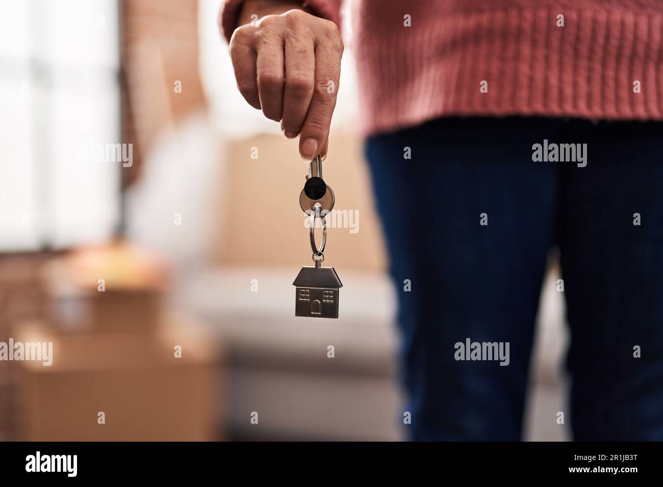 Middle age woman holding key at new home Stock Photo - Alamy