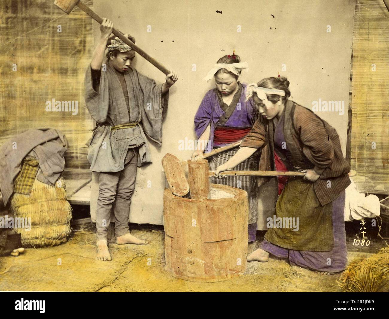 Women making mochi, rice cake made from glutinous rice, Japanese traditional dinner, especially for New Year, 1860, Japan, Historic, digitally restored reproduction from a 19th century original  /  Frauen bei der Herstellung von Mochi, Reiskuchen aus Klebreis, japanisches Traditionsessem, besonders zu Neujahr, 1860, Japan, Historisch, digital restaurierte Reproduktion von einer Vorlage aus dem 19. Jahrhundert Stock Photo