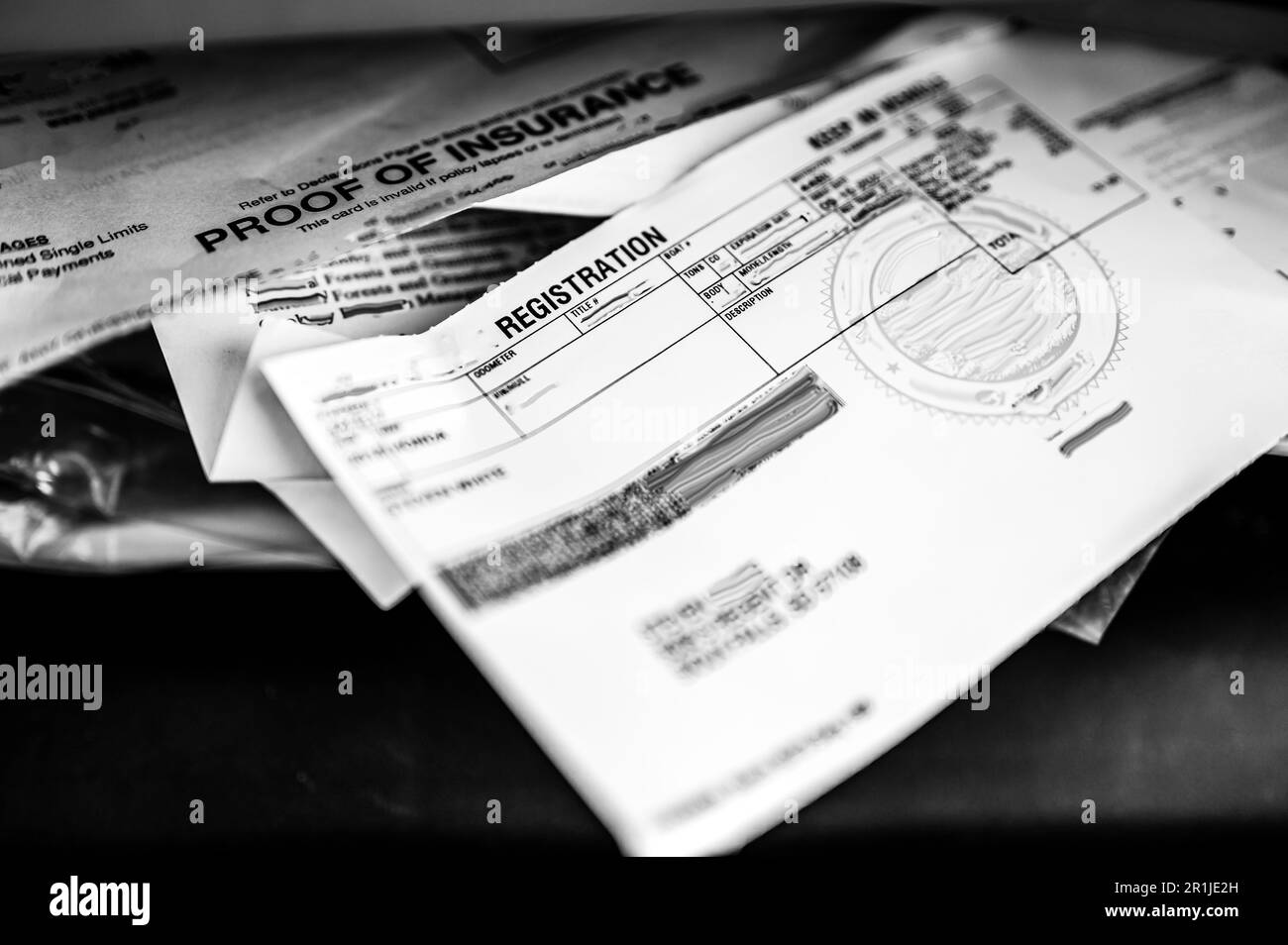 Proof of insurance and vehicle registration documents in the glove compartment of a car Stock