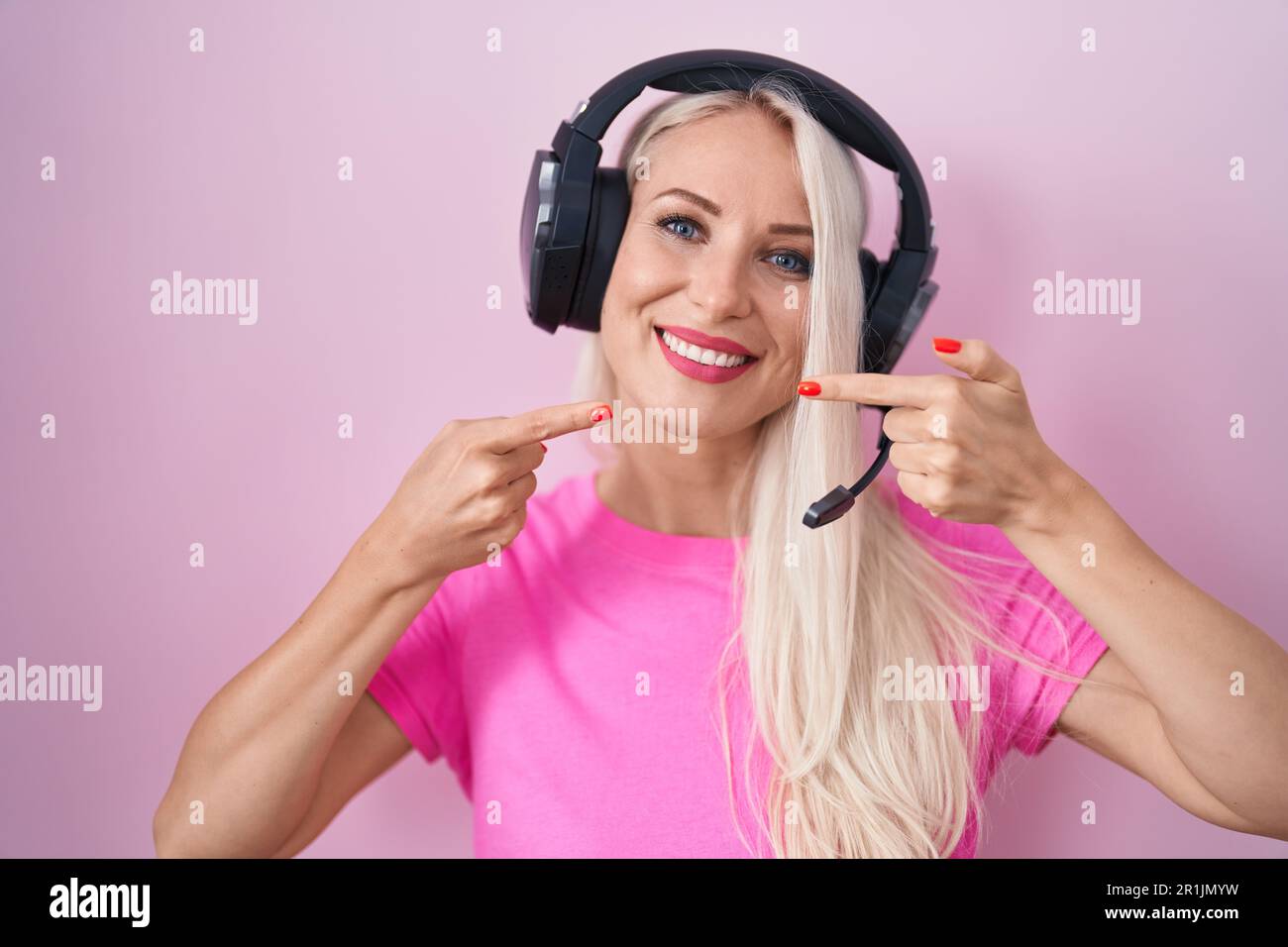 Caucasian woman listening to music using headphones smiling cheerful ...