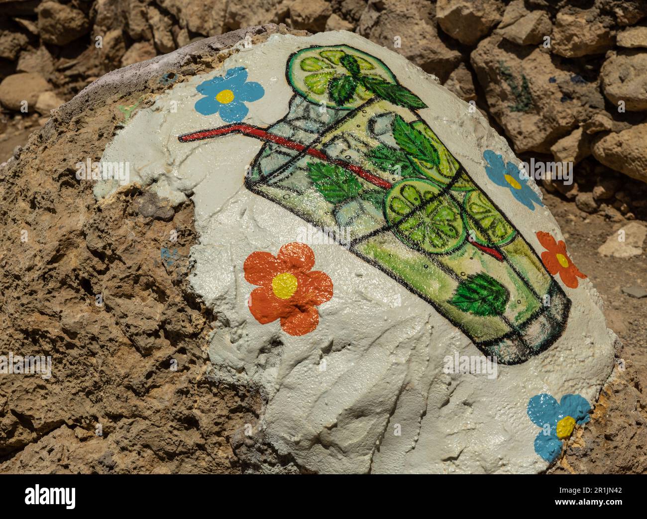 Image of a glass with a mojito cocktail on a stone near a bar on Red Beach, Greece, Crete, Matala Stock Photo