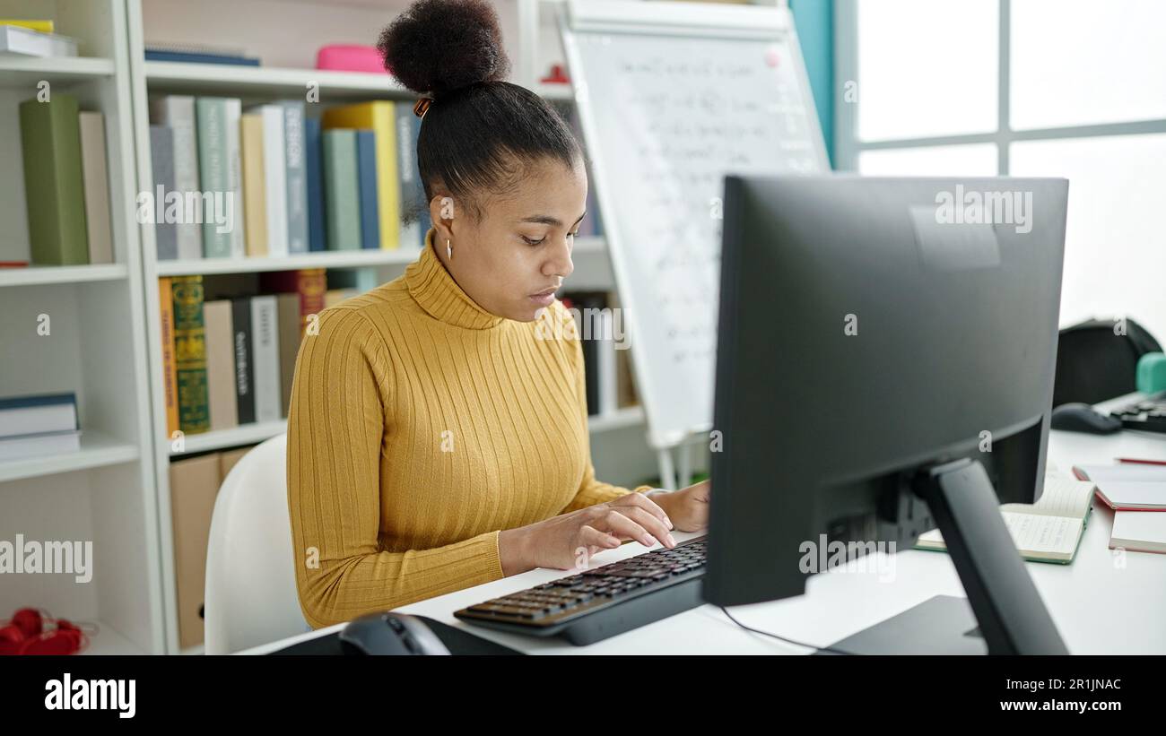 Young african american woman student using computer studying at the ...