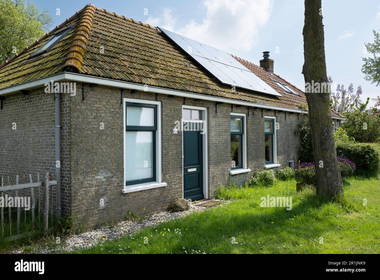 Older renovated small rural house in a green environment with solar ...
