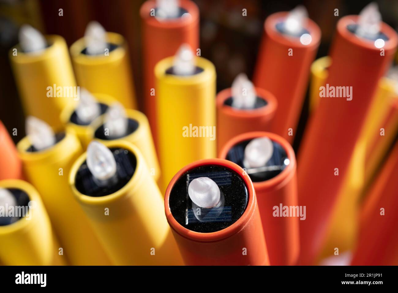 Red, orange and yellow torches with solar powered lights. Focus on the