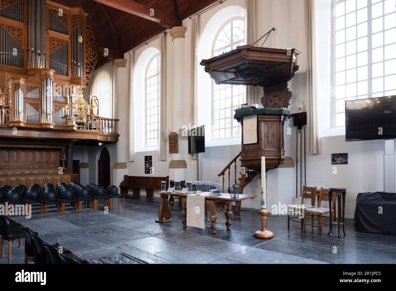 Interior of the protestant 'Hobbe van Baerdt' church with organ, pulpit, large arched windows