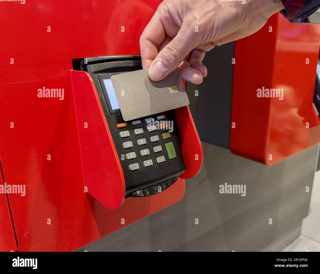 Hand paying with bank card at selfservice ordering kiosk, machine, POS