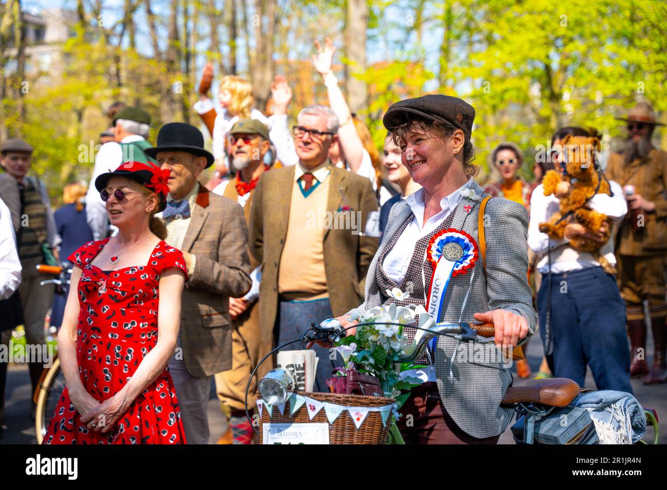 Tweed Run 2023 Bicycle Event - Vintage Dress Up middle aged woman in Crowd Smiling - Vintage bike event Stock Photo
