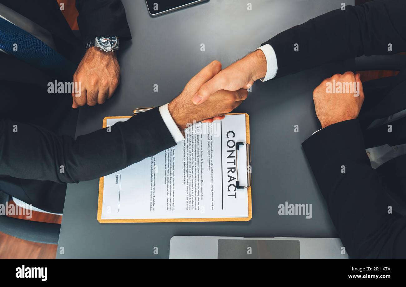 Two professionals successfully close business deal with top view