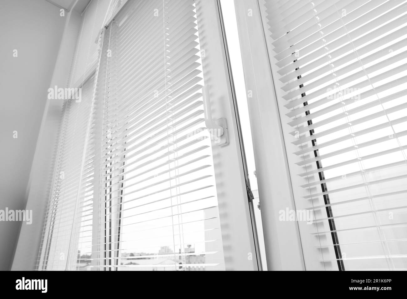 Stylish window with horizontal blinds in room, low angle view Stock Photo